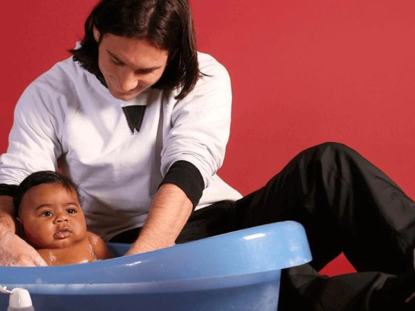 Lionel Messi helping bathe baby Lamine Yamal during a 2007 UNICEF charity calendar photoshoot